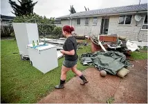  ?? LAWRENCE SMITH/ STUFF ?? Residents clean up in Camphora Pl in Auckland’s Ranui following devastatin­g floods.