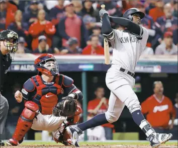  ?? Gregory Shamus/Getty Images ?? Yankees shortstop Didi Gregorius hits the first of his two home runs in ALDS Game 5 Wednesday night in Cleveland. The Yankees went on to beat the Indians, 5-2.