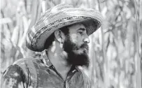  ??  ?? In this April 14, 1966 file photo Castro stands in a sugarcane plantation in Cuba.
