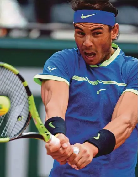  ?? EPA PIC ?? Rafael Nadal returns a shot to Pablo Carreno Busta in the quarter-finals of the French Open at Roland Garros in Paris yesterday.