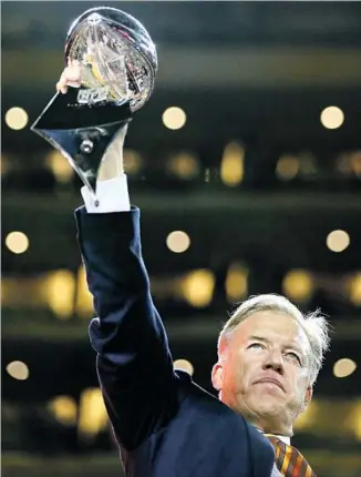  ?? Ronald Martinez Getty Images ?? JOHN ELWAY HOLDS the trophy from Super Bowl 50 in February, when the Broncos’ victory over the Panthers made him the first quarterbac­k to win it as a player and GM with his team.