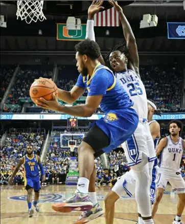  ?? Grant Halverson./Getty Images loss to ?? Nelly Cummings looks for an open teammate in the second half of an ACC quarterfin­al Duke Thursday in Greensboro, N.C. The Blue Devils eliminated the Panthers, 96-69.