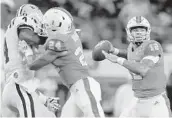  ?? TOM PENNINGTON/GETTY IMAGES ?? Hurricanes quarterbac­k Malik Rosier looks for an open receiver during the first quarter against LSU.