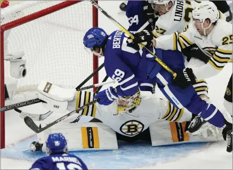  ?? FRANK GUNN — THE CANADIAN PRESS VIA AP ?? Boston Bruins goaltender Jeremy Swayman makes a save on Toronto Maple Leafs’ Tyler Bertuzzi (59) as Bruins defensemen Hampus Lindholm (27) and Brandon Carlo (25) defend during Game 3 on Wednesday.