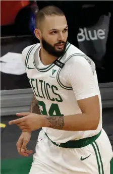  ?? Ap pHOTOS ?? OUT: Celtics wing Evan Fournier landed on the team’s health and safety protocols list on Tuesday night and didn’t play against the Sixers. Far right, Celtics defender Romeo Langford falls behind 76ers forward Tobias Harris on Tuesday night at the Garden.