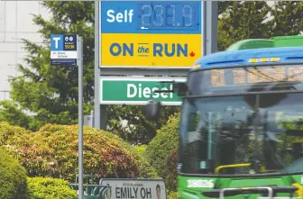  ?? JASON PAYNE ?? A bus passes a gas station on 152nd Street in Surrey on Tuesday. The B.C. Green party is calling on the government to make transit free for four months amid sky-high gas prices.