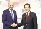  ?? KIYOSHI OTA AP ?? President Joe Biden shakes hands with Japanese Prime Minister Fumio Kishida on Thursday.