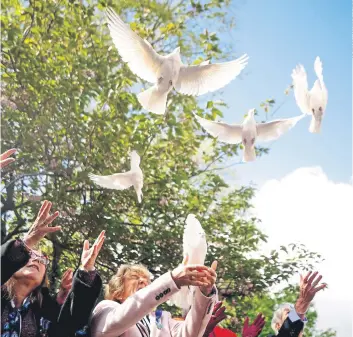  ?? ?? TRIBUTE: White doves are released during a 40th anniversar­y memorial service for Pc Yvonne Fletcher, inset, in St James’s Square, London. Pc Fletcher was murdered on April 17, 1984, by a shot fired from the Libyan embassy.