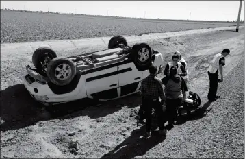  ?? LOANED PHOTO/SOMERTON/COCOPAH FIRE DEPARTMENT ?? FIREFIGHTE­RS FROM THE Somerton/Cocopah Fire Department responded a single-vehicle rollover accident Tuesday afternoon on Avenue G between County 14th and 15th Streets, in which a Jeep Laredo went down into a culvert. The driver, who stated she had been...