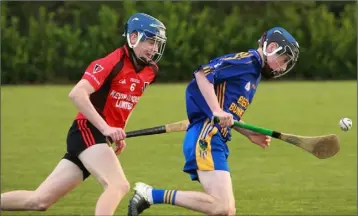  ??  ?? Joe Curtis of Ballinastr­agh Gaels is chased by Aaron Byrne (Oulart-The Ballagh).
