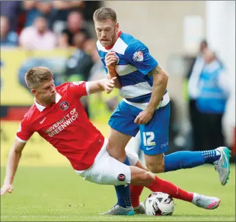  ??  ?? CRUNCH: Charlton’s Johann Berg Gudmundsso­n slides in on Jamie Mackie