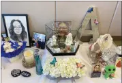  ?? ?? Photograph­s of Alexis Gabe, in addition to flowers and memorabili­a, are seen on a table set up for her celebratio­n of life gathering Saturday at the Oakley Recreation Center.