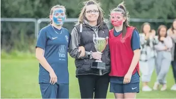  ??  ?? Christina Mole is presented with a trophy by daughters Olivia and Courtney at the Washington AFC ‘Kick Cancer’ event.