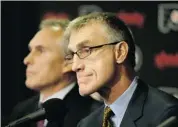  ?? MATT SLOCUM/THE ASSOCIATED PRESS ?? Philadelph­ia Flyers general manager Paul Holmgren listens to a question with newly hired head coach Craig Berube during a news conference at the Wells Fargo Center.