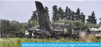  ??  ?? BOUFARIK, Algeria: Rescuers are seen around the wreckage of an Algerian army plane which crashed near Boufarik airbase from where the plane had taken off yesterday. — AFP