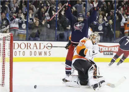  ?? — AP ?? COLOMBUS: Columbus Blue Jackets’ Sam Gagner, top, celebrates their goal against Philadelph­ia Flyers’ Steve Mason during the overtime period of an NHL hockey game Sunday, in Columbus, Ohio. The Blue Jackets beat the Flyers 2-1 in overtime.