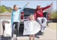  ??  ?? Locklyn Abrecht, 5, holds a sign for the teacher parade last week hosted by Williams Elementary teachers and other staff. They all drove throughout the streets of their school boundaries to greet their students. Locklyn is with her grandparen­ts, Lori and Brad Blew, both retired from Farmington School District. Locklyn will attend Folsom Elementary in the fall.