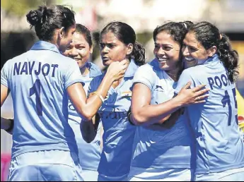  ?? AFP ?? Indian women’s hockey team players celebrate after scoring the opening goal against England on Sunday. India registered an upset 21 win over the world No 2 side.