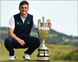  ??  ?? James Sugrue with the Amateur Championsh­ip trophy following his stunning victory at Portmarnoc­k Golf Club in June of last year.