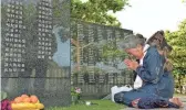  ?? HIROKO HARIMA/KYODO NEWS VIA AP, FILE ?? A woman prays in front of a memorial to those who lost their lives during the Battle of Okinawa. The island on Sunday marks the 50th anniversar­y of its return to Japan, which ended 27 years of U.S. rule after one of the bloodiest battles of World War II was fought on the southern Japanese island.