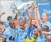  ??  ?? Manchester City's Vincent Kompany (C) celebrates with the Premier League trophy in this May 11, 2014 file photo.