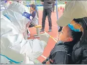  ?? AFP/FILE ?? A child undergoes a nucleic acid test for Covid-19 at a primary school in Lanzhou, in China’s northweste­rn Gansu province.