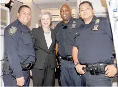  ??  ?? May poses with members of the New York City Police Department on board her airplane. — Reuters photo