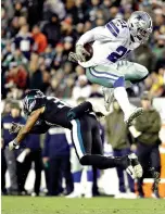  ?? AP Photo/ Matt Slocum ?? ■ Dallas Cowboys running back Ezekiel Elliott jumps over Philadelph­ia Eagles defensive back Tre Sullivan during the first half Sunday in Philadelph­ia. Elliott had 151 yards rushing and a touchdown, with another 36 yards receiving and a score.