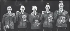  ?? DITA ALANGKARA/AP ?? Canada’s Shallon Olsen, Isabela Onyshko, Ellie Black, Jade Chrobok and Brittany Rogers show off their gold medals won Friday in team artistic gymnastics at the Commonweal­th Games.