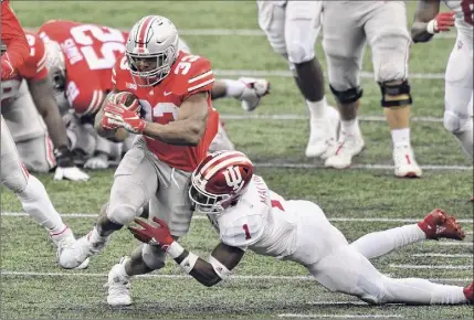  ?? Jamie Sabau / Getty Images ?? Master Teague of Ohio State ran for a career-high 169 yards against Indiana on Saturday. The Buckeyes’ running attack helped the team run out the clock on two late drives against the Hoosiers.