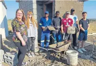  ??  ?? Doing their bit are Emily Burns, Megan Duncan, Rhys Jones and Tarmo Tsotsi with local tradesmen