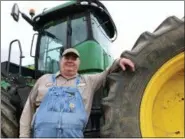  ?? DYLAN LOVAN - THE ASSOCIATED PRESS ?? In this June 20 photo, farmer Bernard Peterson leans on a tractor at his farm in Loretto, Ky. When the Trump administra­tion announced a $12 billion aid package for farmers struggling under the financial strain of his trade dispute with China, the payments were capped. But records obtained by The Associated Press under the Freedom of Informatio­n Act show that many large farming operations easily found legal ways around the limits to collect big checks. At Peterson’s farm, eight members of the family partnershi­p collected a total $863,560 for crops they grow on over 15,000 acres in seven counties, including wheat and corn used at the nearby Maker’s Mark bourbon distillery. Peterson said that it didn’t make up for all their losses at a time when it was already hard to be profitable. The $1.65 per bushel aid payments for soybeans fell well short of losses he estimated at $2 to $2.50 per bushel, factoring in the loss of the Chinese market that took years to develop.