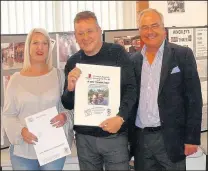  ??  ?? Anna and Simon Clough from The Rising Sun in Shackersto­ne received a certificat­e from Camra chief executive Tim Page, right, at the tenth Hinckley Beer Festival to mark their pub’s inclusion in the 2018 Good Beer Guide. Picture: Alan Cooke