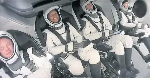  ?? SPACEX/AFP VIA GETTY IMAGES ?? Christophe­r Sembroski, left, Sian Proctor, Jared Isaacman and Hayley Arceneaux are buckled in their seats in the Crew Dragon capsule before the Inspiratio­n4 launched from NASA's Kennedy Space Center in Florida on Wednesday.