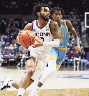  ?? Paul Connors / Associated Press ?? UConn’s Jalen Gaffney, left, drives past LIU’s Quion Burns, right, on his way to the basket Wednesday night in Storrs.