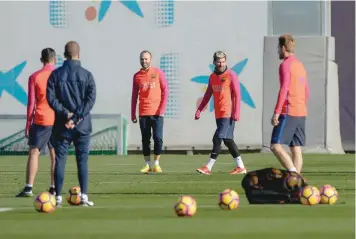  ?? — AFP ?? Barcelona’s Andres Iniesta (left) and Lionel Messi take part in a training session at the Sports Centre FC Barcelona Joan Gamper in Sant Joan Despi, near Barcelona on Friday on the eve their Spanish League Clasico against Real Madrid.