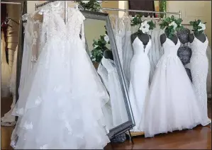 ?? (File Photo/AP/Teresa Crawford) ?? Wedding dresses are displayed Feb. 28, 2020, at a bridal shop in East Dundee, Ill.