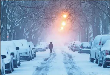  ?? Sun-Times-Tyler LaRiviere / Chicago ?? A woman walks down Glenlake Avenue towards North Clark Street as a winter storm batters Chicago, on Saturday.