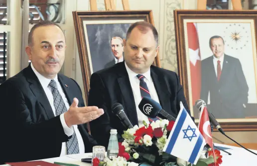  ?? ?? Foreign Minister Mevlüt Çavuşoğlu (L) delivers an opening statement before meeting with Israeli and Turkish businesspe­ople, in Tel Aviv, Israel, May 25, 2022.
