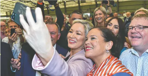  ?? CLODAGH KILCOYNE/REUTERS ?? Sinn Fein deputy leader Michelle O'Neill and party leader Mary Louise McDonald take a selfie on Saturday in Magherafel­t, Northern Ireland, after Sinn Fein was voted in as the largest party