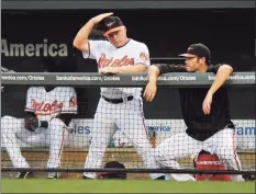  ?? Gail Burton / Associated Press ?? Orioles manager Buck Showalter signals during a game against the Angels in 2010.