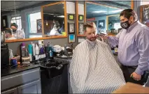  ?? STEVE MARCUS ?? Andres Dominguez gives a cut to customer Johan Ehde at the Speakeasy Barbershop LV inside El Cortez.