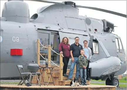  ??  ?? TRANSFORME­D: Martyn Steedman with wife Louise and sons Josh and Harry (front) on the decking steps of their Sea King. Pictures: Andrew Milligan/PA