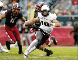  ?? RICH SCHULTZ / AP ?? Central Florida quarterbac­k McKenzie Milton, running against Temple, directs a Knights offffense that leads the nation in scoring at 48.2 points per game.