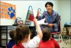  ?? NWA Democrat-Gazette/CHARLIE KAIJO ?? Teacher Emilia Ortiz leads a lesson on rhyming Thursday at Tennie Russell Primary School in Bentonvill­e. The Bentonvill­e School District is in the fourth week of a six-week pilot program serving students who will be entering kindergart­en in the fall. These kids either have been identified with behavioral concerns or have no preschool experience.