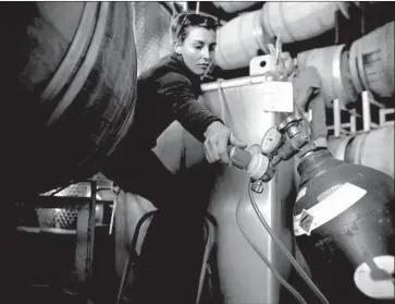  ?? Photograph­s by Liz O. Baylen Los Angeles Times ?? CALIFORNIA’S wine industry sold about $197 million of its product in China last year, but a trade war could kill its momentum. Above, Olivia Bue works in the barrel room at Temecula’s Robert Renzoni winery in 2016.