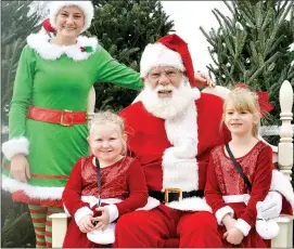  ?? TIMES photograph by Annette Beard ?? Santa’s assistant Esther Cutberth, left, joined Santa as Kayla Trager, 6, and Paisley Hammers, 4, visited with Santa at the Wonderland Christmas Tree Farm Sunday, Dec. 8. Trager, daughter of Matt and Jennifer Trager, and Hammers, daughter of Josh and Becky Hammers, are all of Seligman, Mo.