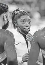  ?? DANIELLE PARHIZKARA­N/ USA TODAY SPORTS ?? Simone Biles talks with fellow gymnasts Tuesday after pulling out of the team final at the Tokyo Olympics.