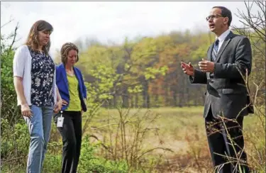  ?? DAKE KANG — THE ASSOCIATED PRESS FILE ?? Green Mayor Gerard Neugebauer speaks to city employees in front of wetlands where a proposed pipeline would run through in Green. The town has hired a law firm to stop the pipeline from being built through the community.