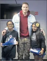  ?? Gina Ferazzi Los Angeles Times ?? BLAKE GRIFFIN is f lanked by students Nasir Lucas, left, and Miranda Morales.